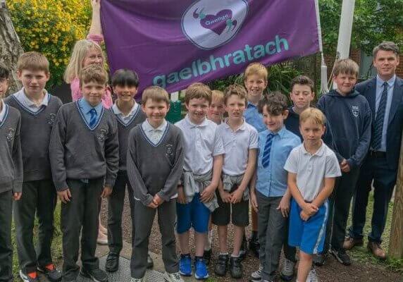 Boys-of-Star-of-the-Sea-with-the-flag-teacher-Faye-Mulhern-and-Principal-Niall-Walsh-min-min